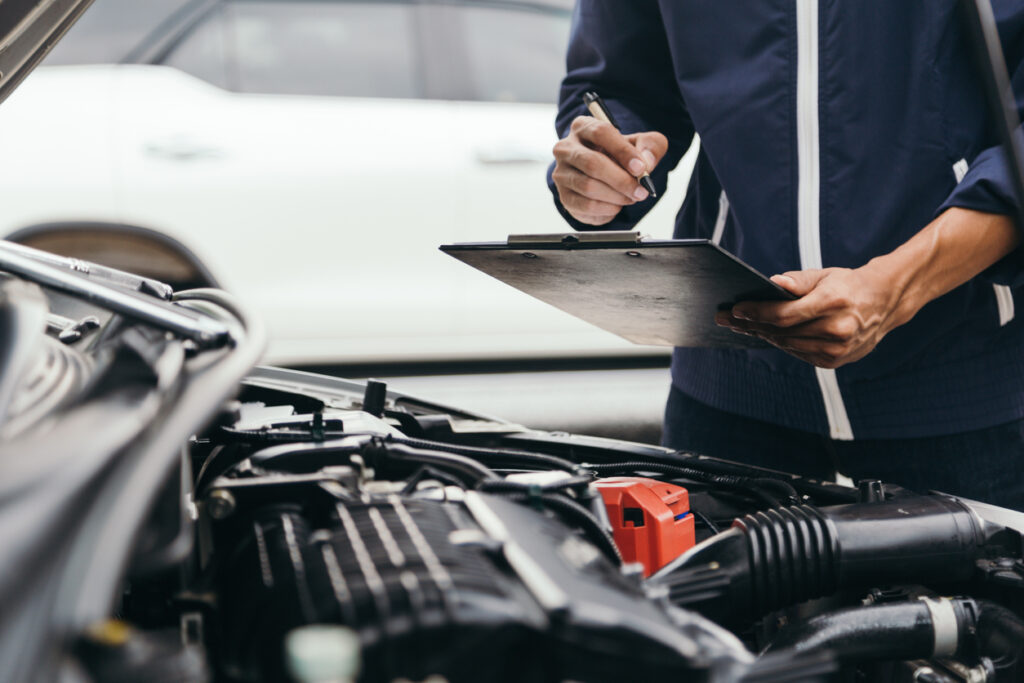 Mechanic reviewing car repair records in California