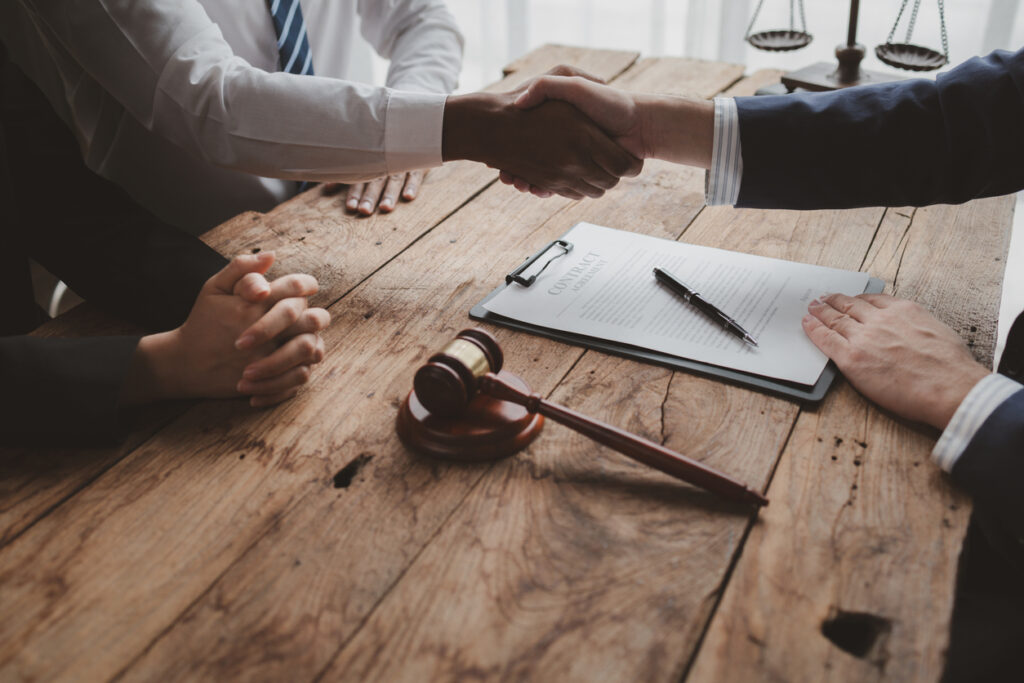 Shaking hands over a lemon law settlement agreement