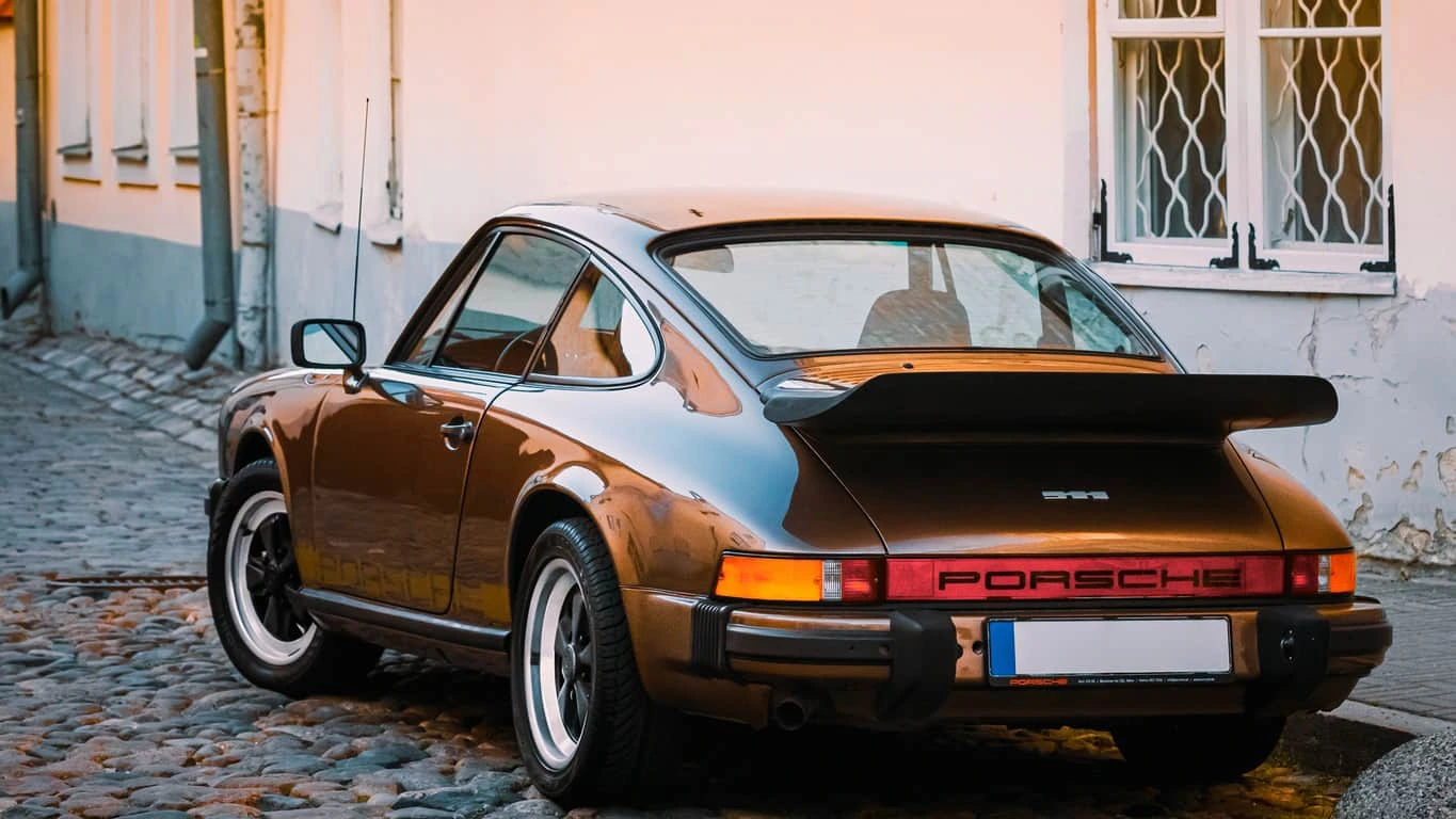 Classic Porsche 911 parked on a cobblestone street, representing Porsche Lemon Law issues in California