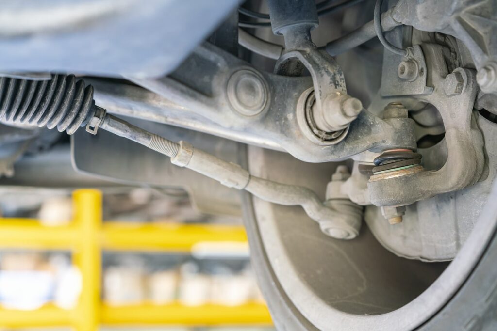 Close-up of a VW Atlas steering rack and suspension system showing potential areas for clunks and suspension issues.