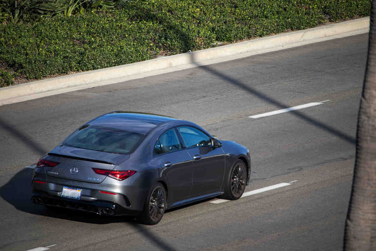 Modern Mercedes-Benz vehicle on the road, highlighting issues related to software malfunctions in Lemon Law claims for luxury cars